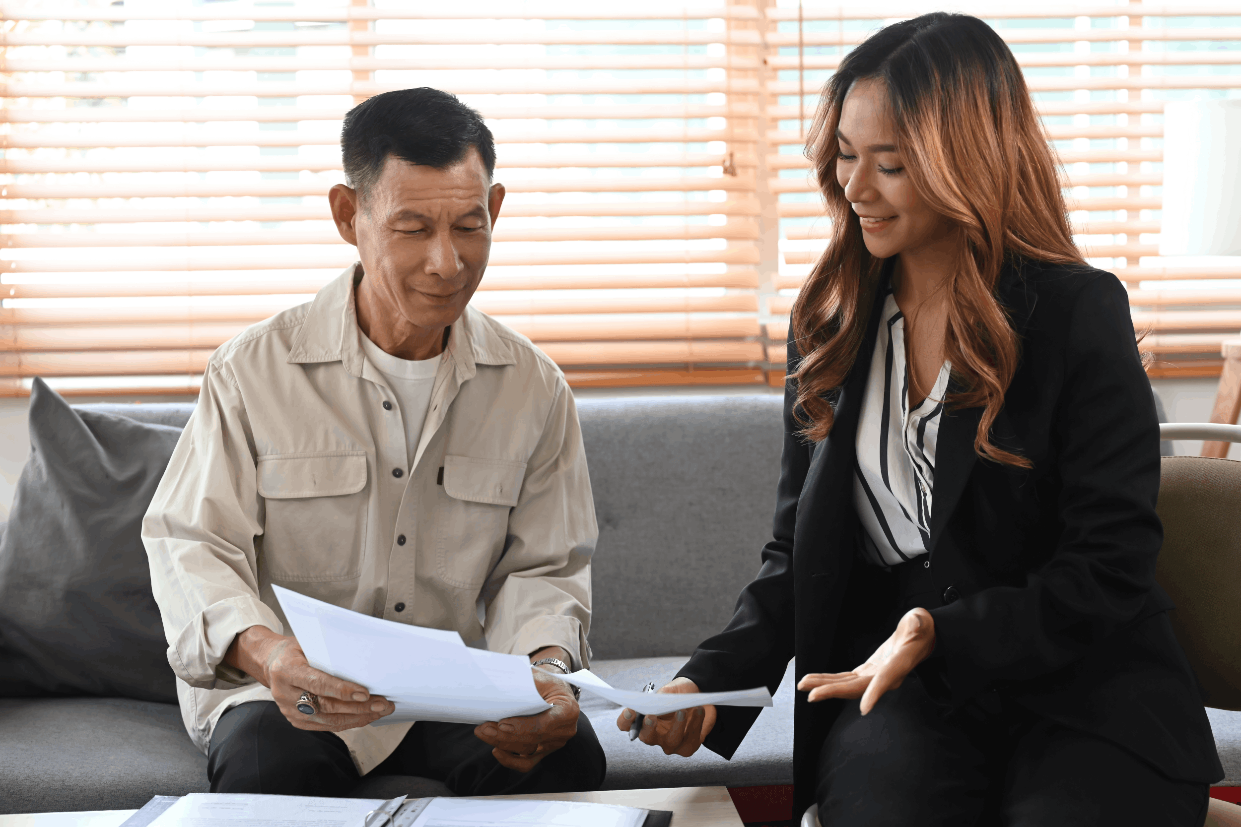 senior-man-reviewing-documents-with-female-profess