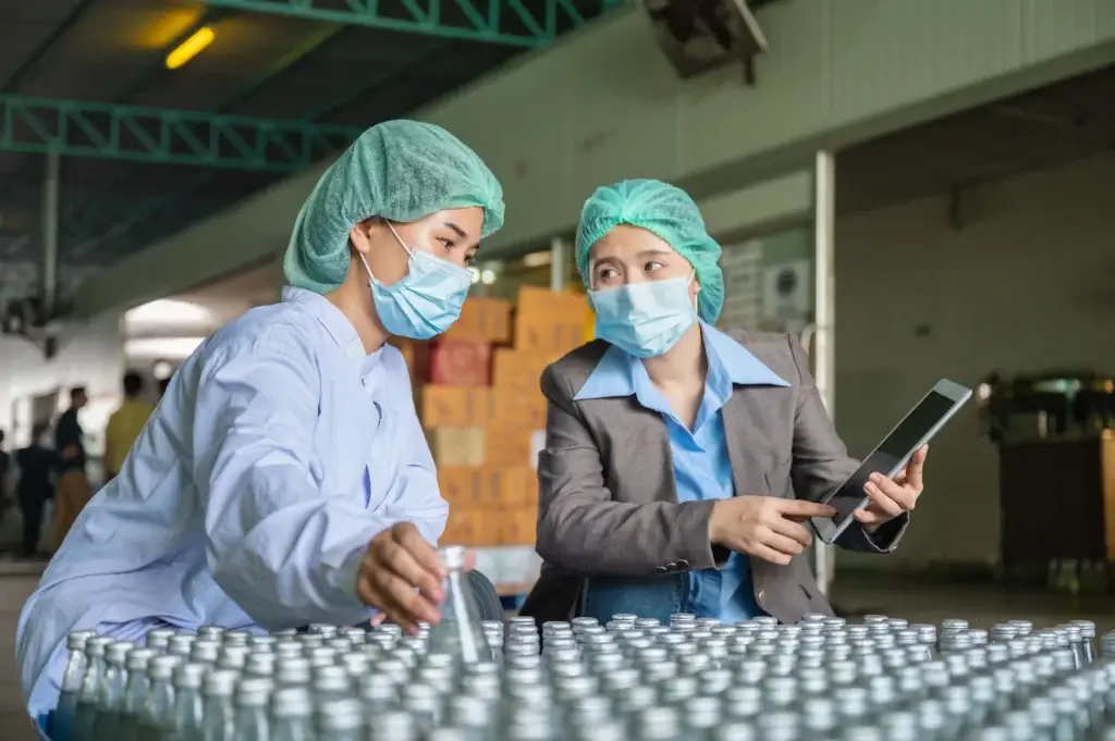 employees-reviewing-bottling-process
